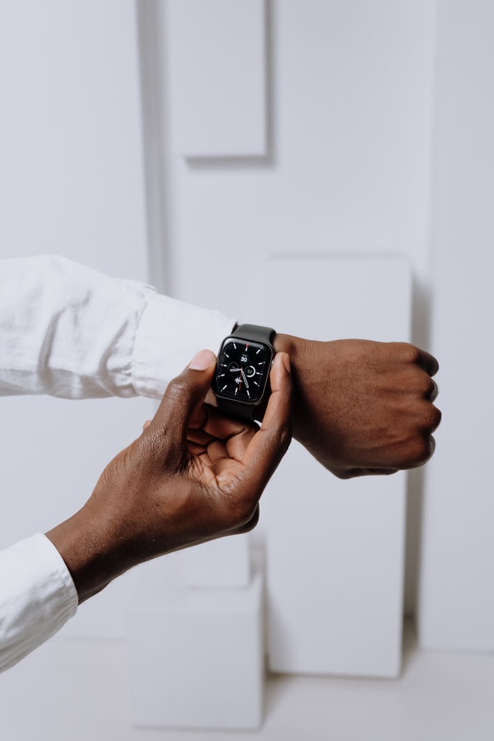 Person Wearing Silver Aluminum Case Apple Watch With White Sport Band